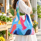 Greatly Blessed Highly Favored Deeply Loved colourful reusable shopping bag carried at an outdoor market with groceries