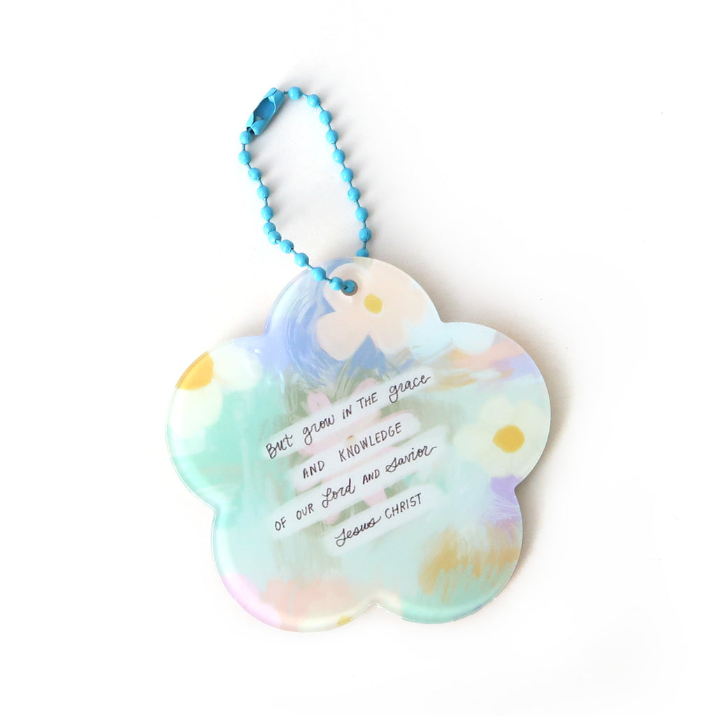 Flower-shaped Christian keychain featuring the text 'But grow in the grace and knowledge of our Lord and Savior Jesus Christ,' designed as an inspirational faith-based accessory.