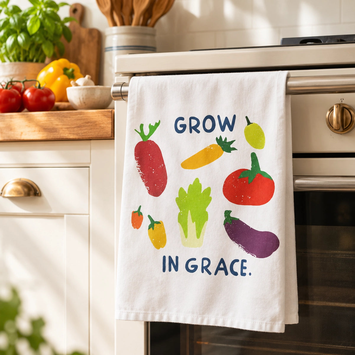 Grow in Grace tea towel hanging on an oven rail in a warm sunlit kitchen.