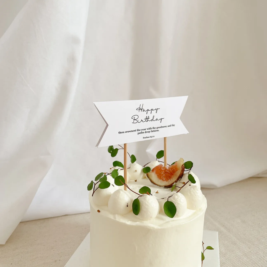 Birthday flag decor with Psalm 65:11 printed in elegant script