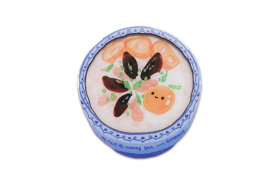 Christian congee coaster with blue porcelain style border and “He fills the hungry soul with goodness” Scripture text.