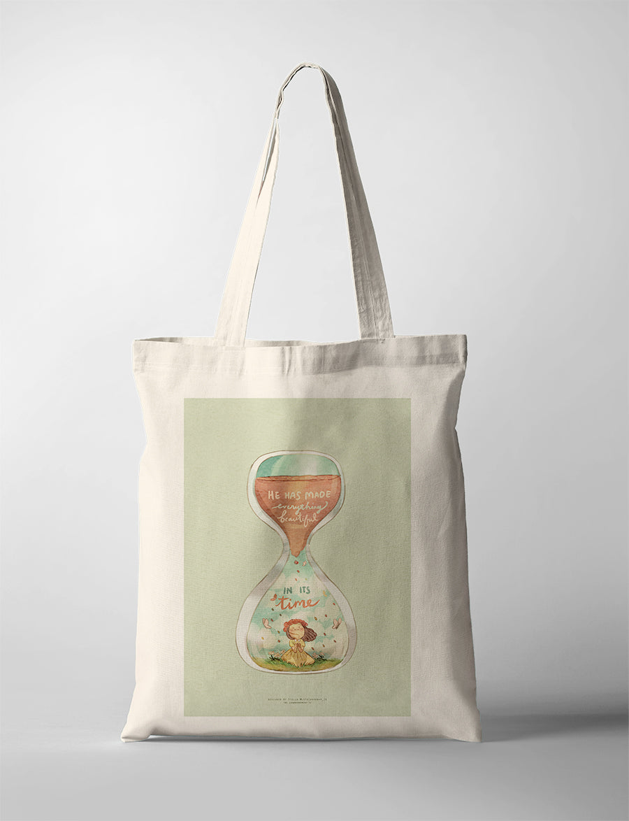 Christian tote bag with illustrated hourglass and the verse “He has made everything beautiful in its time” from Ecclesiastes 3:11