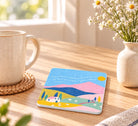 Psalm 23 He makes me lie down in green pastures Christian coaster in a bright sunlit home setting