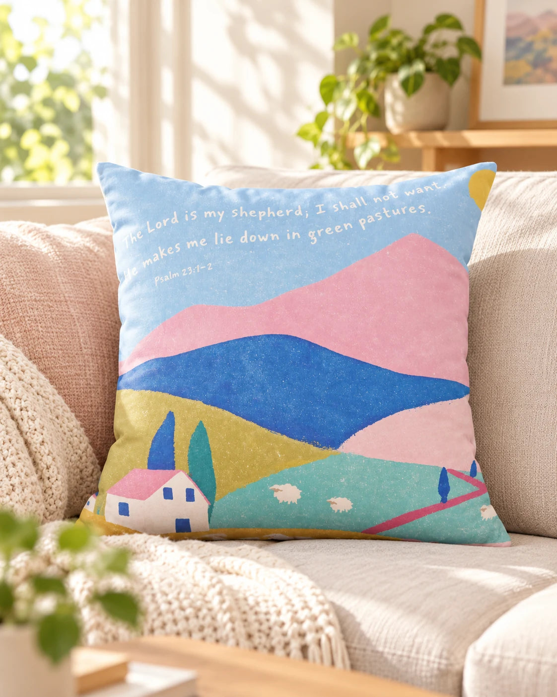 Psalm 23 He Makes Me Lie Down in Green Pastures Christian cushion cover with pastel landscape on a sofa.