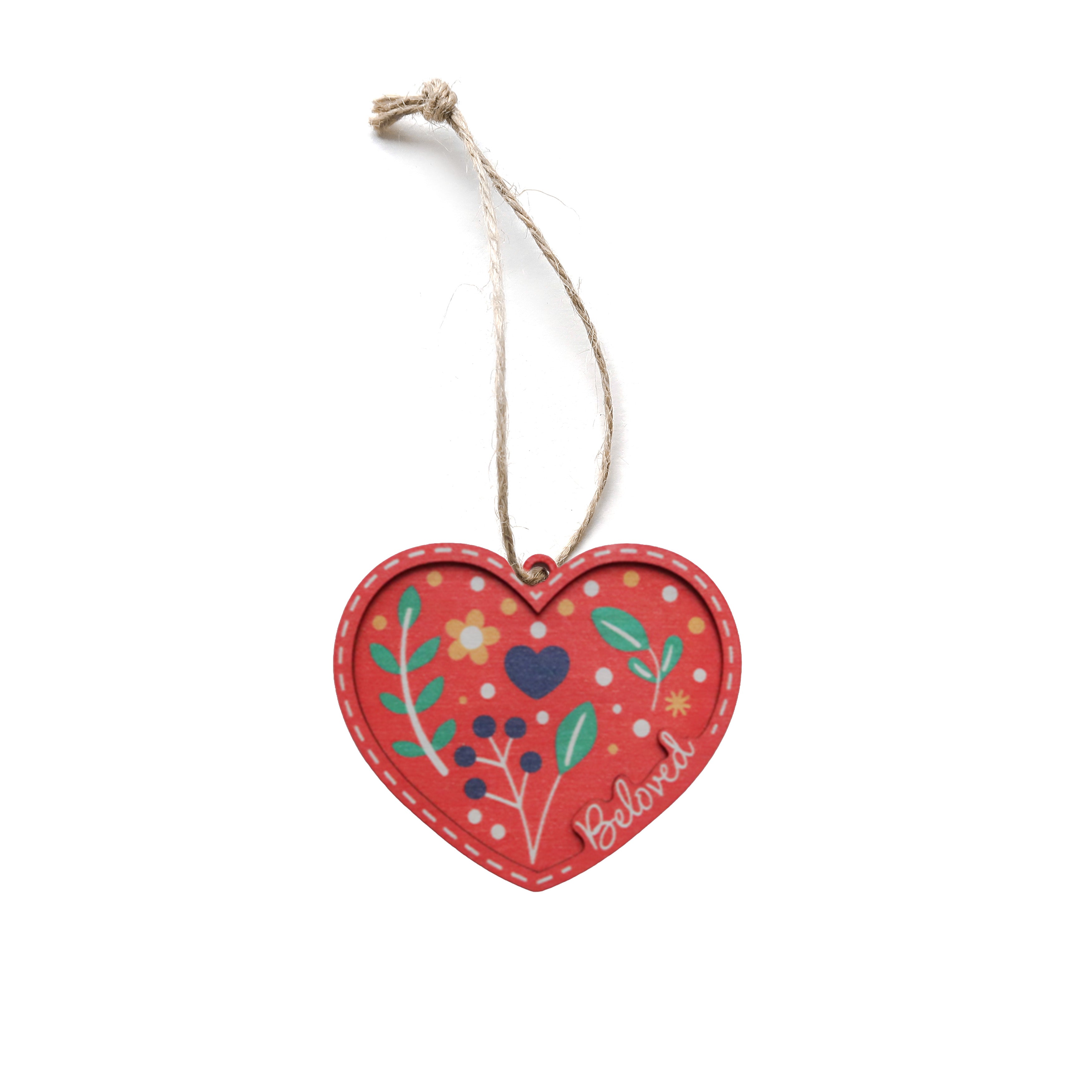 Red heart-shaped Christmas tree bauble with floral design and the word ‘Beloved’.