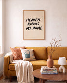 Heaven Knows My Name Christian poster styled above a warm living room sofa
