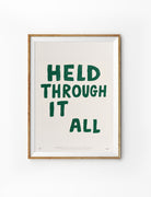 Held Through It All Christian poster in a light wood frame