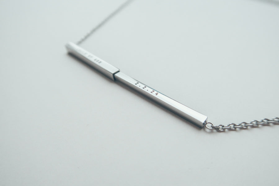 J&Co Foundry hidden-message bar necklace in a personalised jewellery display.
