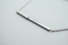 J&Co Foundry hidden-message bar necklace in a personalised jewellery display.