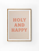 Holy and Happy Christian poster in a light wood frame