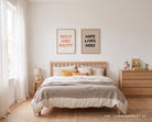 Holy and Happy poster displayed with Hope Lives Here wall art in a bedroom