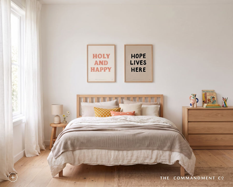 Holy and Happy poster displayed with Hope Lives Here wall art in a bedroom