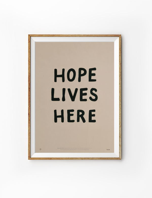 Hope Lives Here Christian poster in a light wood frame