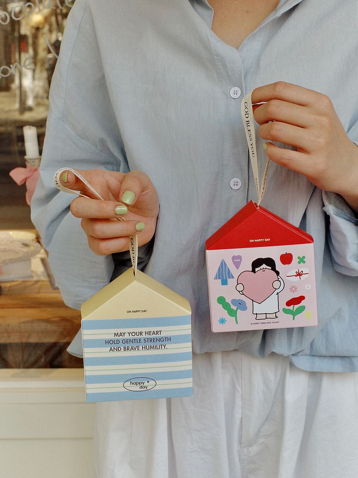 Cute house shaped gift box with ribbon handle featuring Christian inspired design and soft pastel illustration