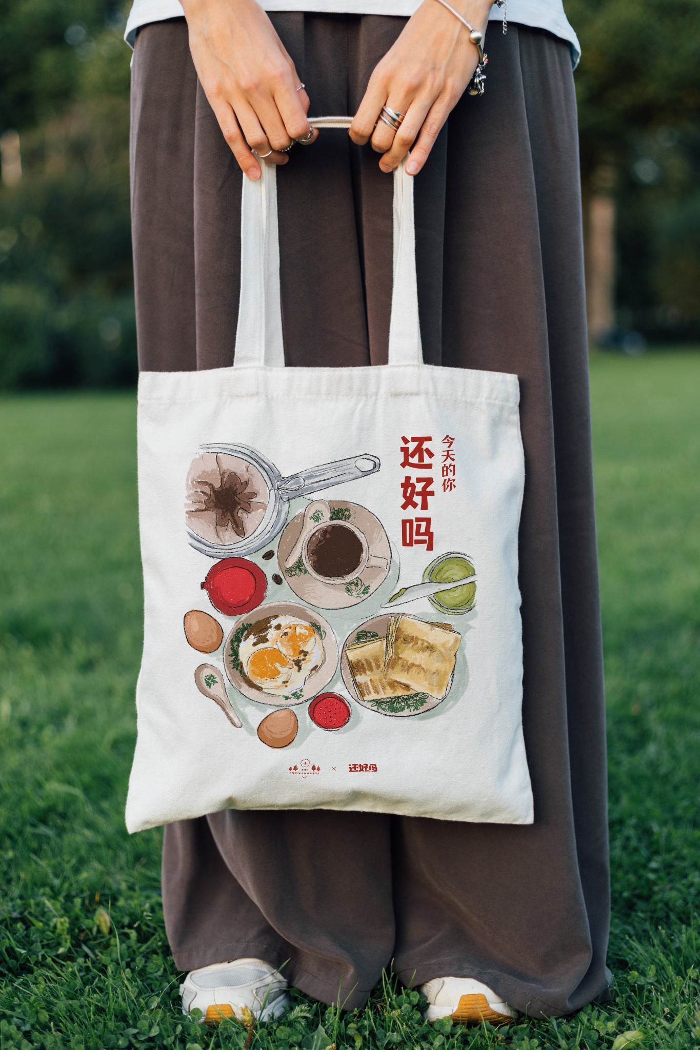 Person carrying the How Are You Today Chinese breakfast tote bag outdoors