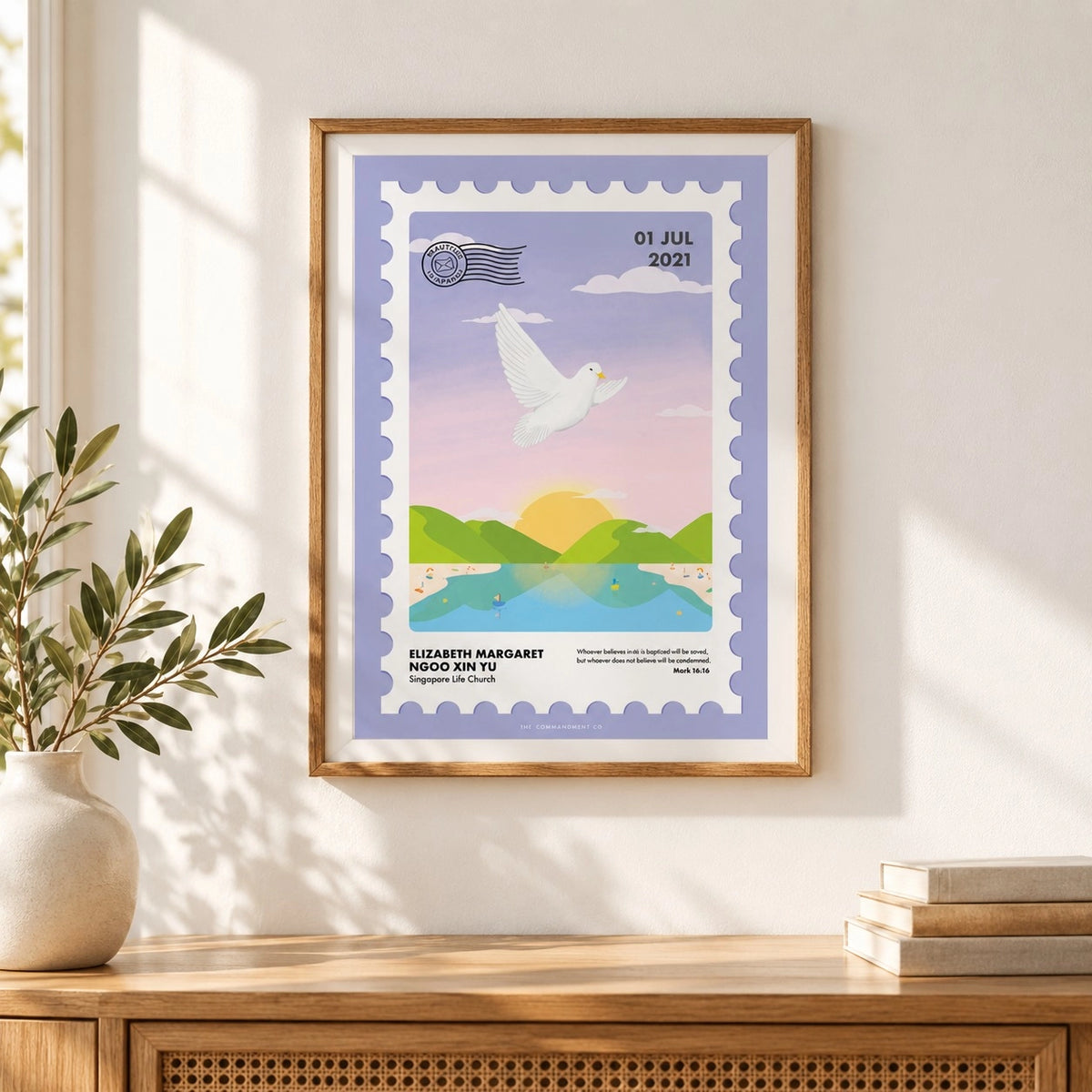 Customisable I Am Baptised postage stamp Christian poster displayed in a wooden frame on a sunlit wall.