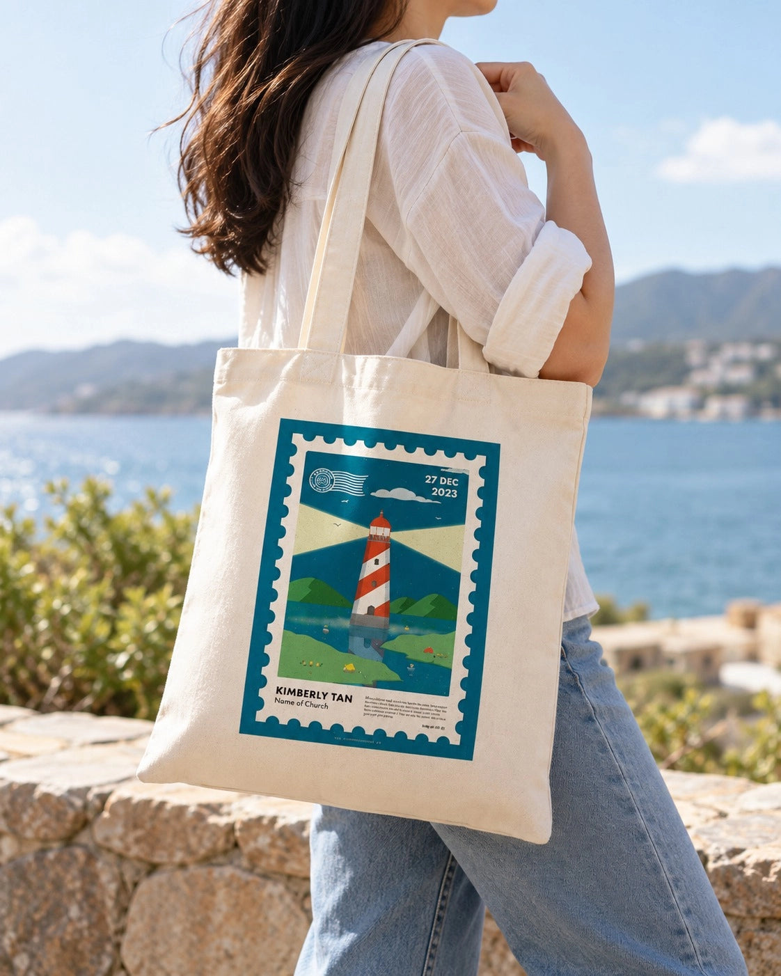 I Am Baptised customisable postage stamp tote bag carried outdoors by the sea.