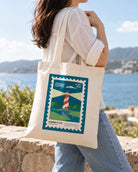 I Am Baptised customisable postage stamp tote bag carried outdoors by the sea.