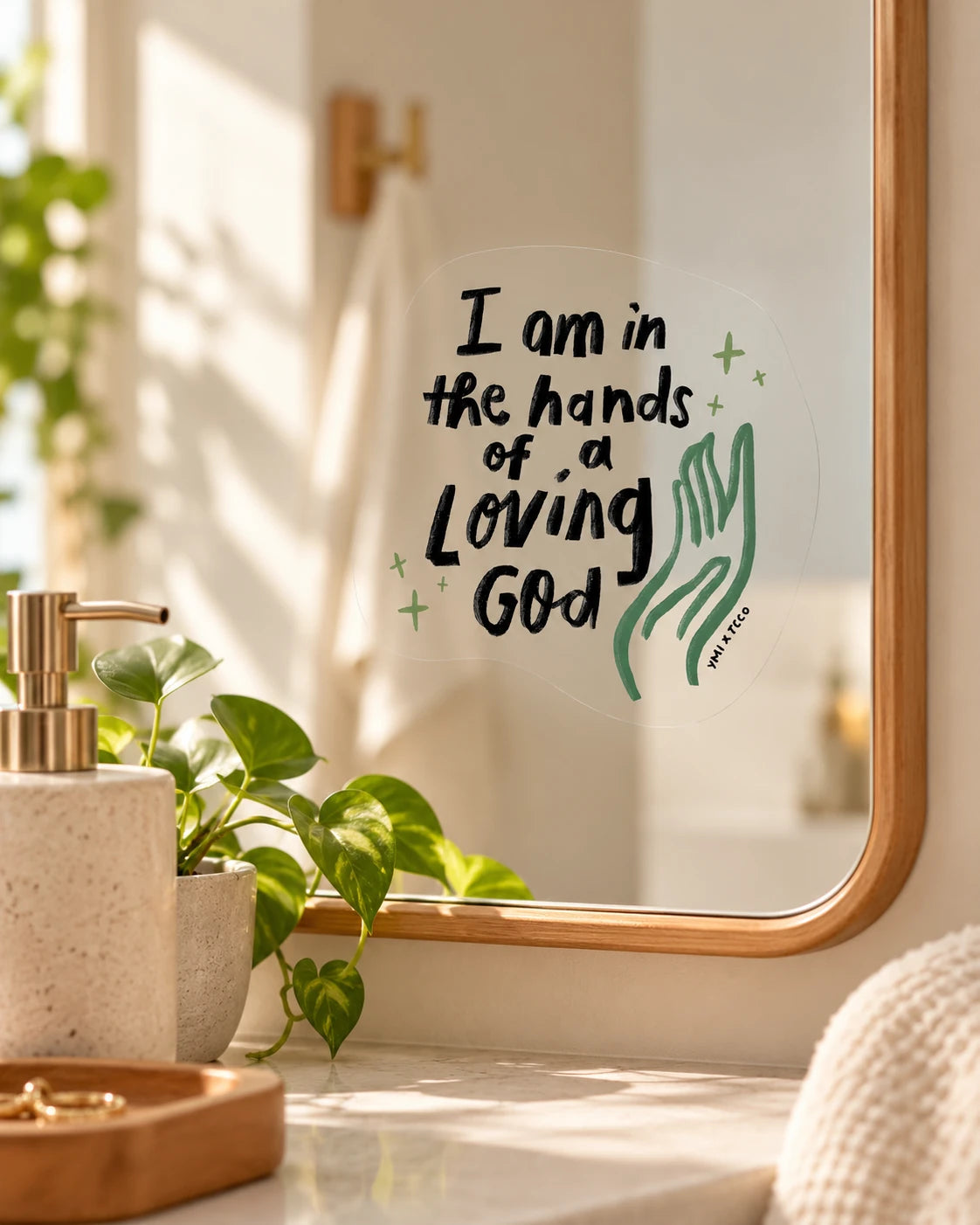 I am in the hands of a loving God transparent mirror decal in a warm vanity setting