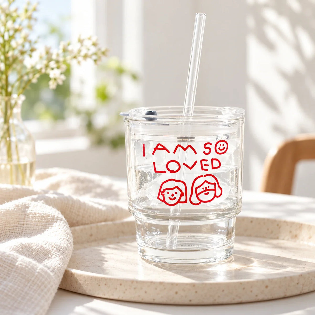 I Am So Loved glass tumbler with straw on cream tray in warm natural light