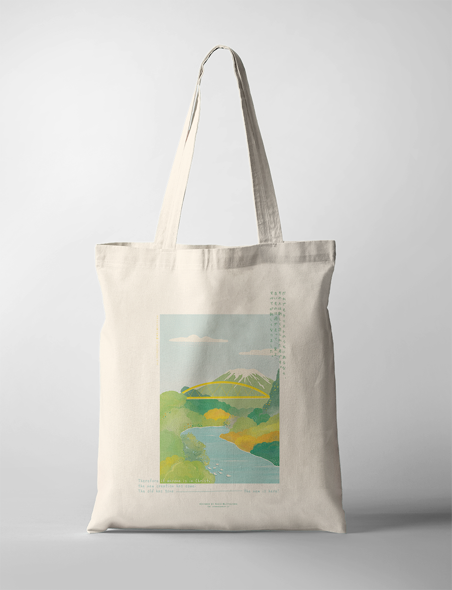 Neutral canvas tote bag featuring a serene landscape illustration with mountains, river, and greenery, paired with the uplifting message "In Christ" and scripture, reflecting simple happiness and faith-inspired encouragement.