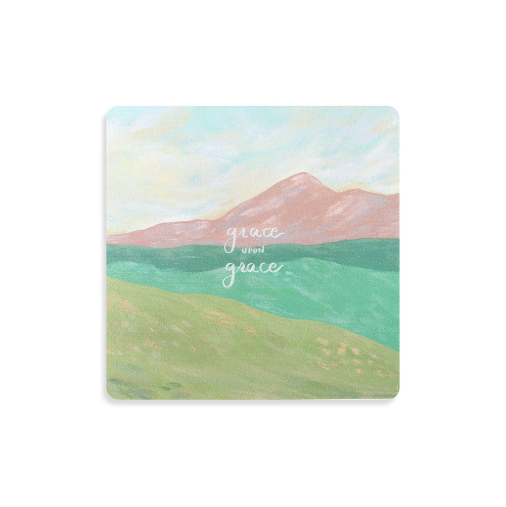 Inspirational Christian coaster featuring the words 'Grace upon grace' with a pastel mountain landscape design, ideal for faith-based home decor.