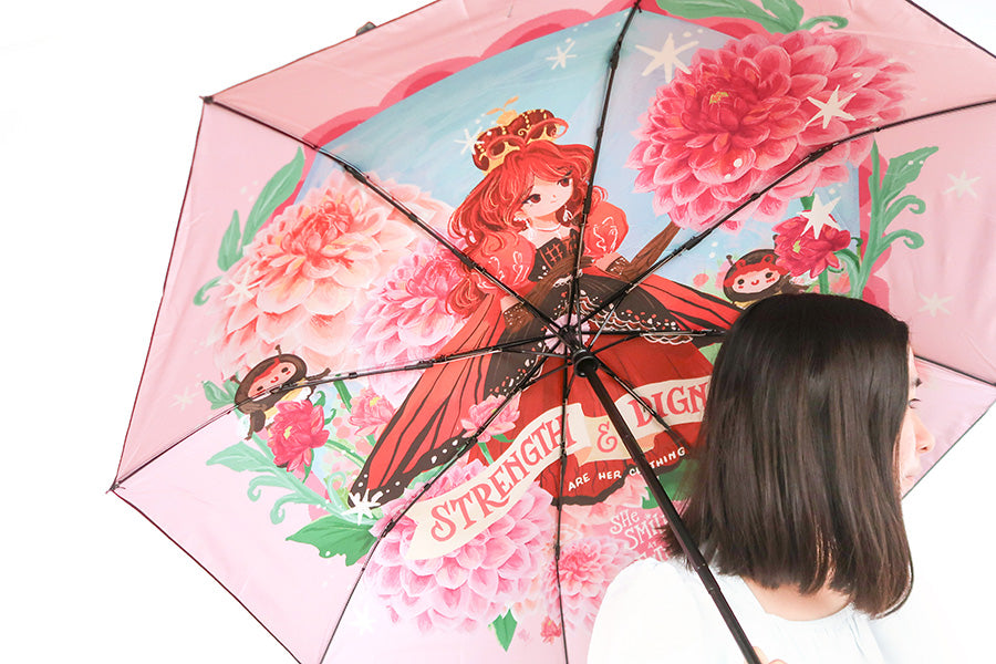 Floral umbrella with 'Strength and Dignity' verse, a Christian accessory for inspiration and motivation.