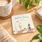 Jalan-Jalan with Jesus Christian coaster on a sunlit wooden table