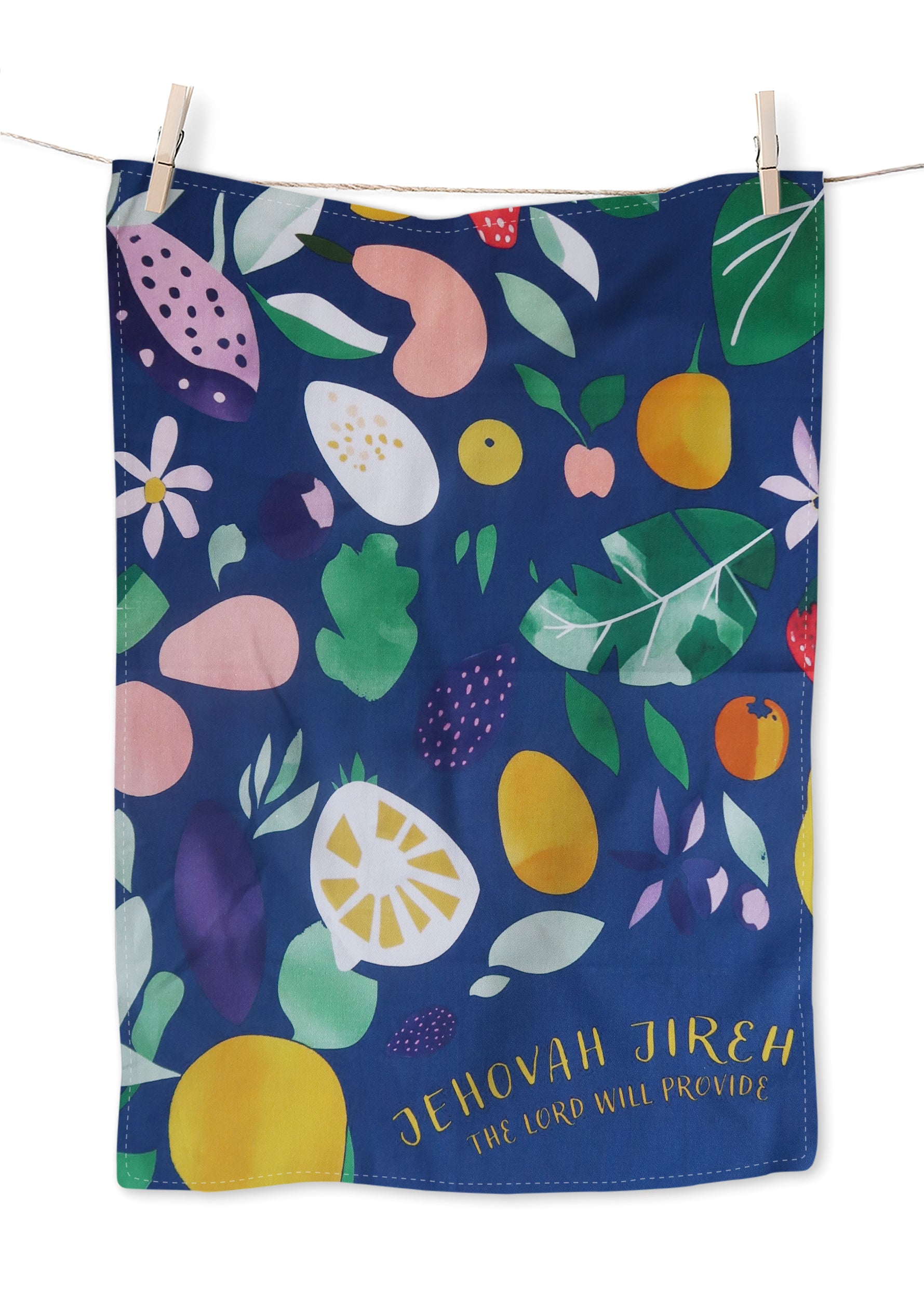 Blue tea towel with a vibrant fruit pattern and gold scripture "Jehovah Jireh — The Lord Will Provide," a Christian home decor gift from The Commandment Co.