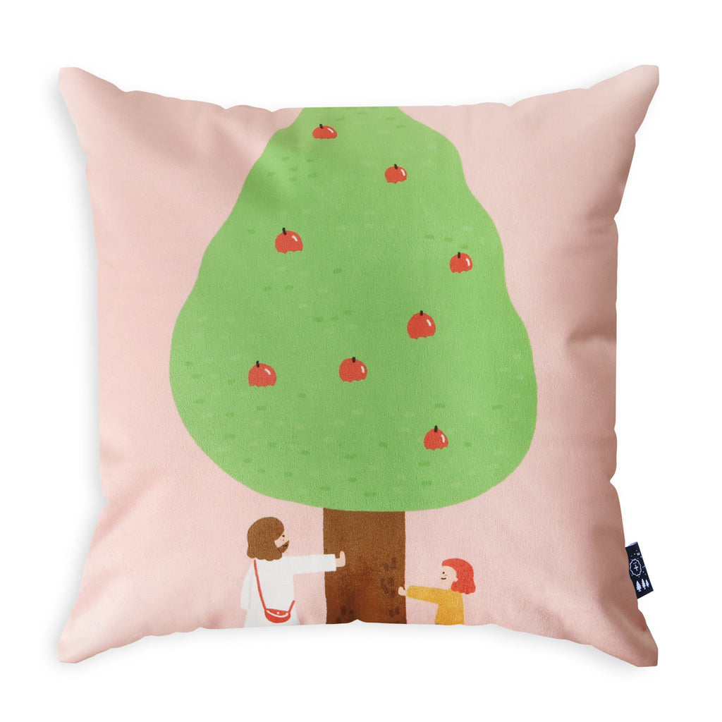 Decorative throw pillow featuring an illustration of Jesus and a child standing under an apple tree with a pink background, designed for Christian faith-based home decor.