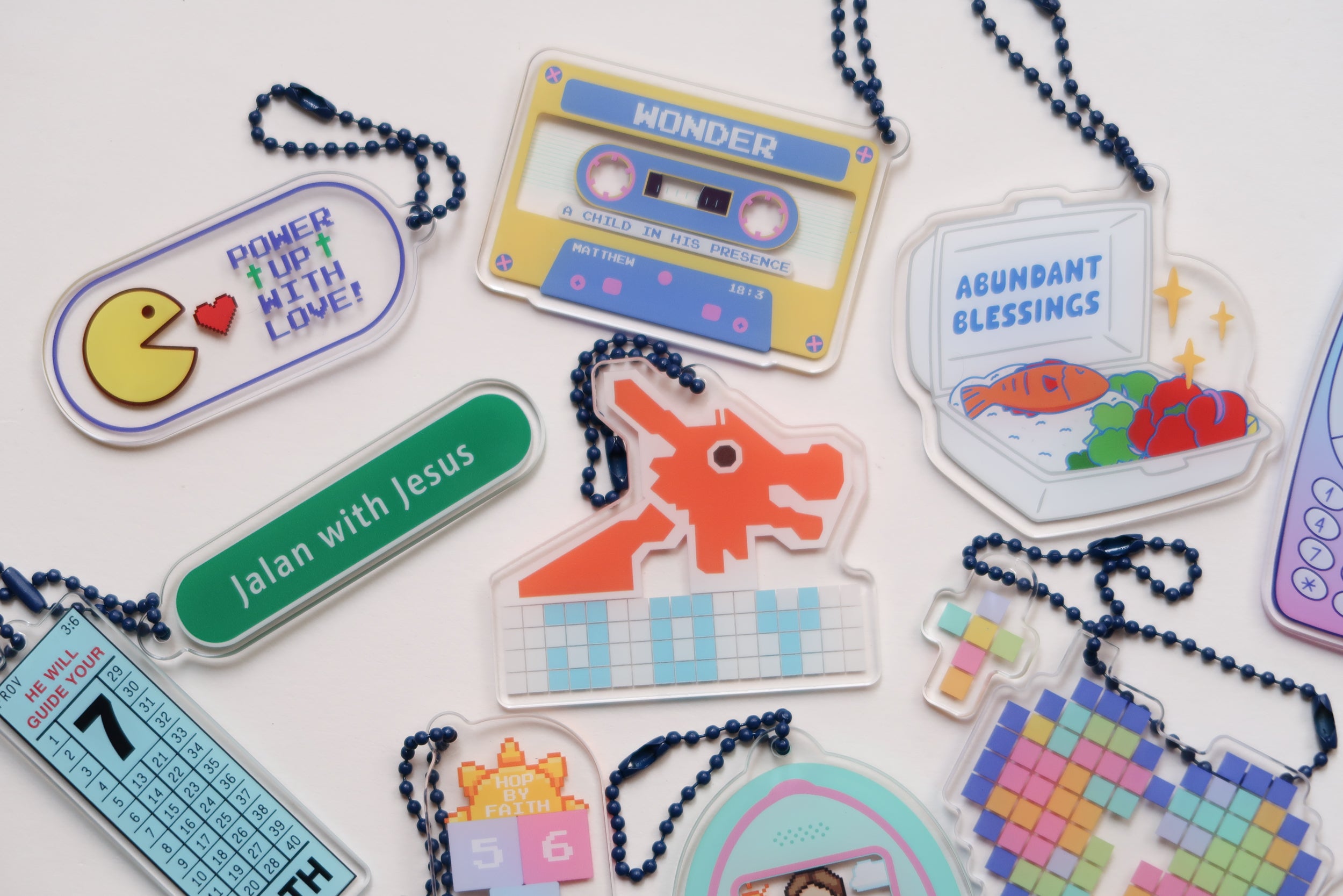  A vibrant collection of Jesus children's day acrylic keychains featuring playful designs like "Power Up With Love," "Jalan with Jesus," and "Abundant Blessings," inspiring faith, joy, and simple happiness for kids.