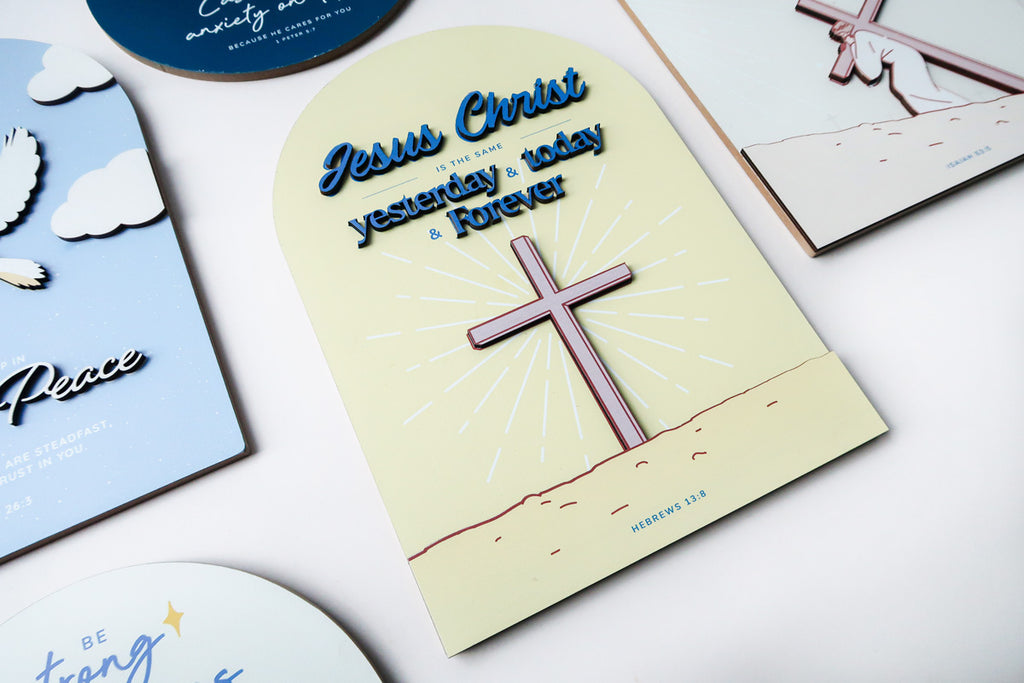 3D wooden Christian poster featuring the phrase 'Jesus Christ is the same yesterday, today, and forever,' with a cross illustration and the Bible verse Hebrews 13:8, displayed alongside other designs.