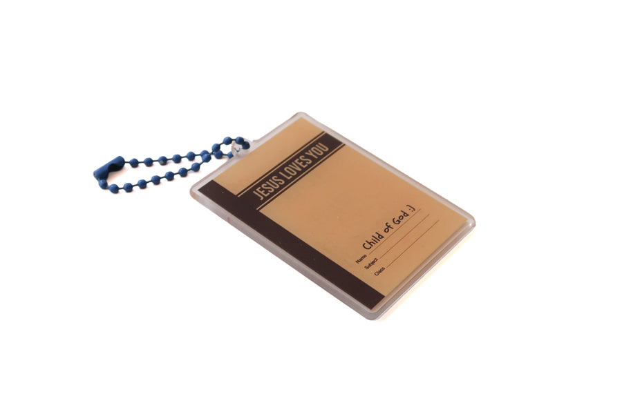Angled view of Jesus Loves You jotter book-inspired acrylic keychain with blue ball chain
