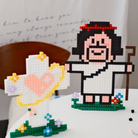  Micro building sets featuring a joyful Jesus figure with a shepherd’s staff and a cross adorned with a heart and flowers, symbolizing hope, light, and simple happiness. 