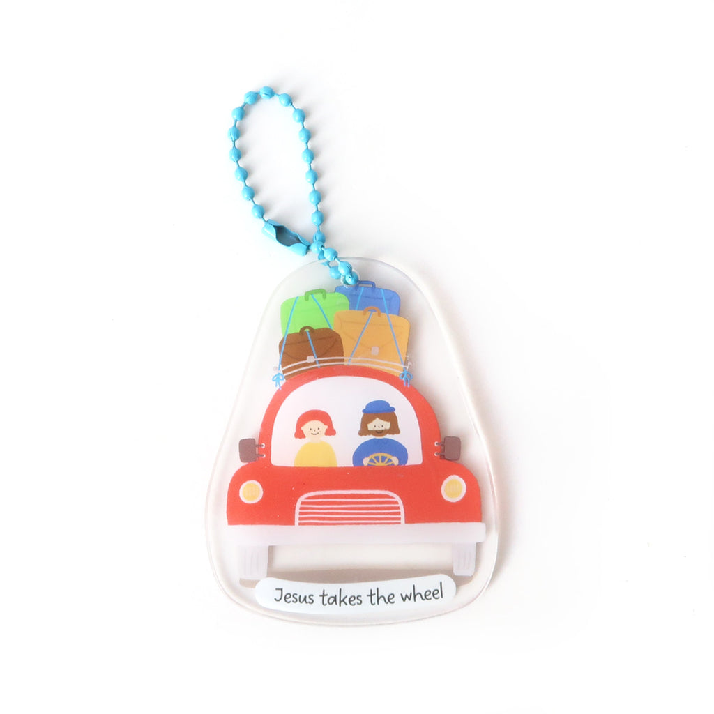 Christian keychain featuring the phrase 'Jesus takes the wheel,' with an illustration of Jesus driving a car with luggage on top, designed as an inspirational travel accessory.