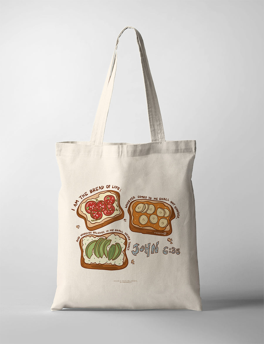 Canvas Christian tote bag with illustrated bread and toppings design featuring the verse “I am the bread of life” from John 6:35