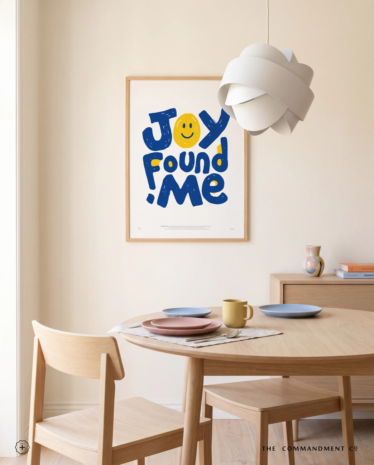 Joy Found Me poster displayed in a bright dining room with light wood furniture and pastel tableware
