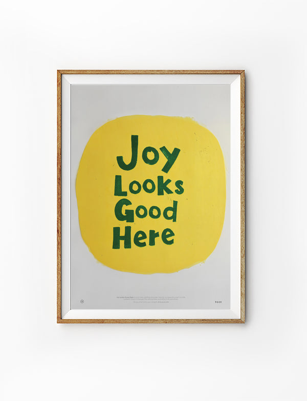 Joy Looks Good Here Christian poster with dark green lettering on a hand-painted yellow circle