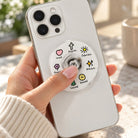 Jesus spinner phone grip featuring faith icons on a white phone held in a hand.