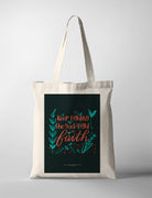 Christian tote bag with dark background and hand lettering ‘Keep Fighting the Good Fight of Faith’ from 1 Timothy 6:12 surrounded by leaves.