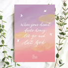 A6 Christian postcard featuring the message “When your heart feels heavy, let go and let God” on a soft pink and lavender sky with white birds.