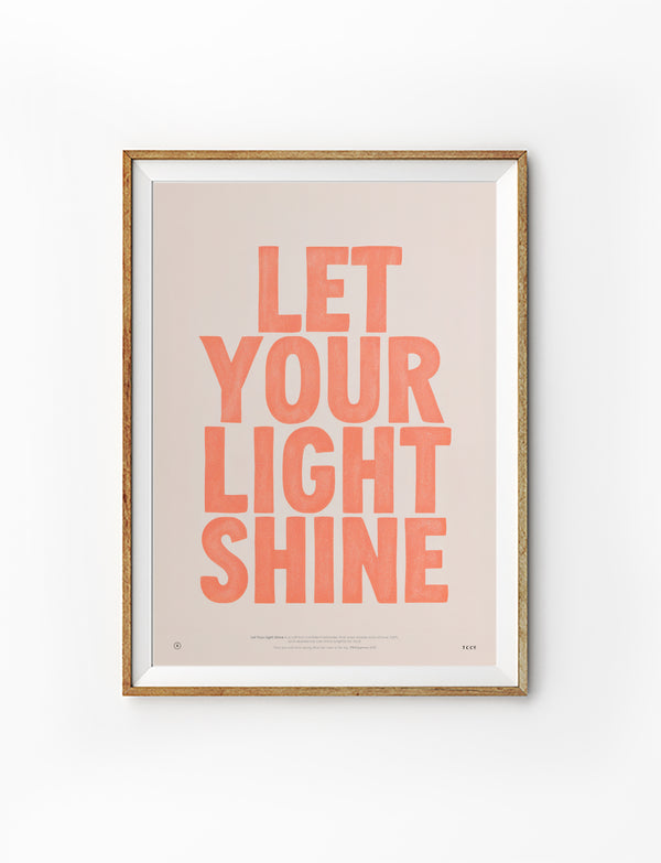 Let Your Light Shine Christian poster with warm coral lettering displayed in a wooden frame on a white background