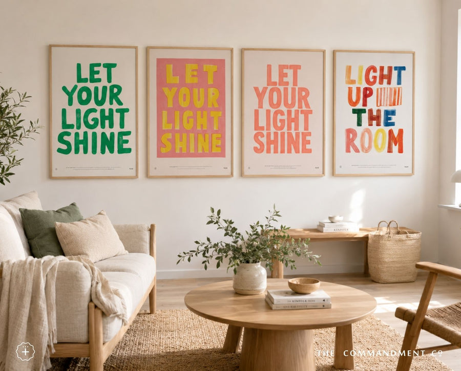 Coral Let Your Light Shine poster displayed with colourful Christian posters in a bright living room