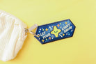 Inspirational keychain with colorful stars and the message 'Let Your Light Shine.'