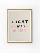 Light Always Wins Christian poster inspired by John 1:5 in a natural wood frame on a white background