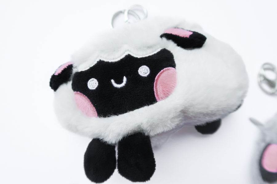 Three faith-inspired Lil Sheepies plush keychains in White Cumulus, Pink Hana, and Stormy Gray are displayed on a white background. Each soft, fluffy sheep represents a reminder of the Good Shepherd’s love, featuring a Bible verse charm, a retractable string for easy card access, and a secure keychain clip. Perfect as a Christian gift or daily faith companion.