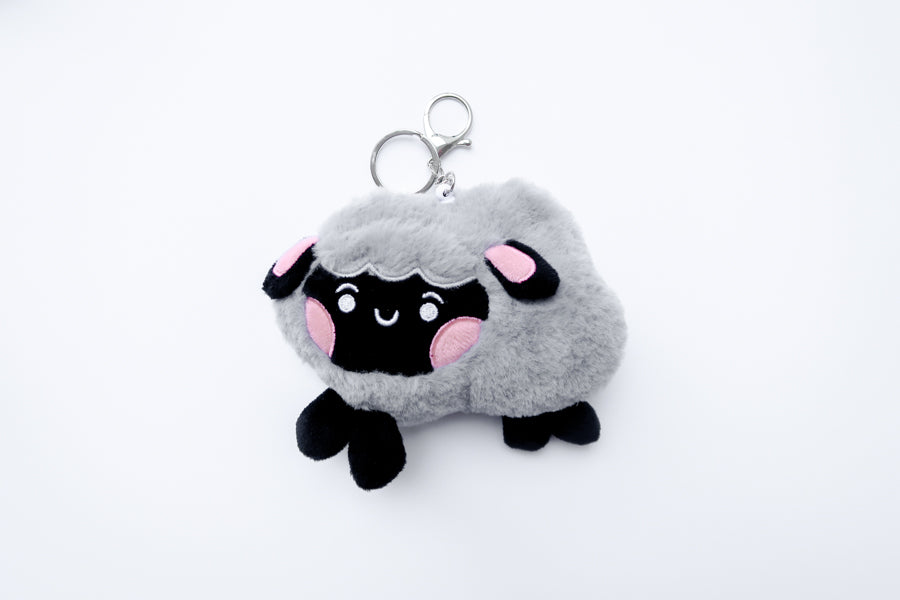 Three faith-inspired Lil Sheepies plush keychains in White Cumulus, Pink Hana, and Stormy Gray are displayed on a white background. Each soft, fluffy sheep represents a reminder of the Good Shepherd’s love, featuring a Bible verse charm, a retractable string for easy card access, and a secure keychain clip. Perfect as a Christian gift or daily faith companion.