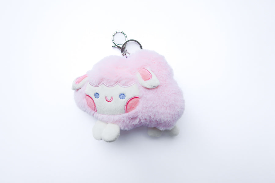 Three faith-inspired Lil Sheepies plush keychains in White Cumulus, Pink Hana, and Stormy Gray are displayed on a white background. Each soft, fluffy sheep represents a reminder of the Good Shepherd’s love, featuring a Bible verse charm, a retractable string for easy card access, and a secure keychain clip. Perfect as a Christian gift or daily faith companion.