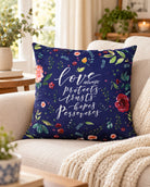 Love Always Christian cushion cover with floral navy design styled on a neutral sofa.