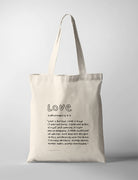 Love Bible verse tote bag featuring 1 Corinthians 13:4-7 in a handwritten typography design on a natural canvas tote.